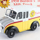 A vintage Borden's Dairy Products milk truck model, featuring a white upper body, yellow lower body, a gray hood, and red stripes, displayed against a themed background with a vintage sign.