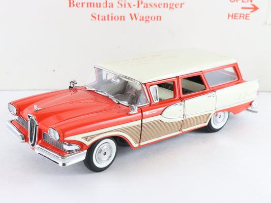 A vintage-style model station wagon toy car in red, cream, and tan, photographed on a plain white background with printed red text above.