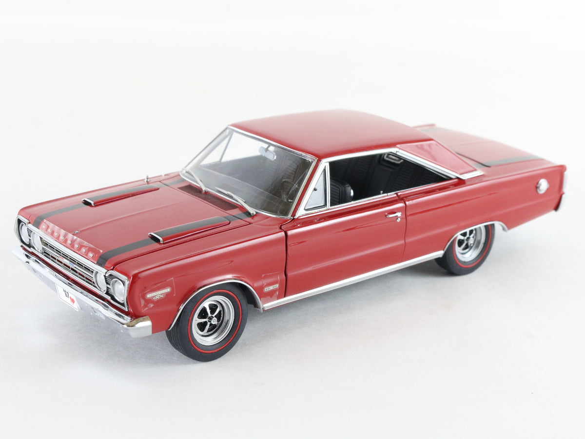 A red die-cast model car, resembling a classic American muscle car, shown from a three-quarters front angle on a clean white background.
