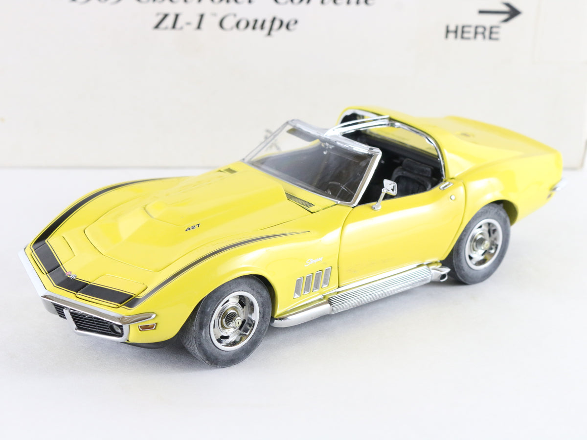 A yellow die-cast model of a 1967 Chevrolet Corvette ZL-1 Coupe, shown from a three-quarters front angle on a white background.