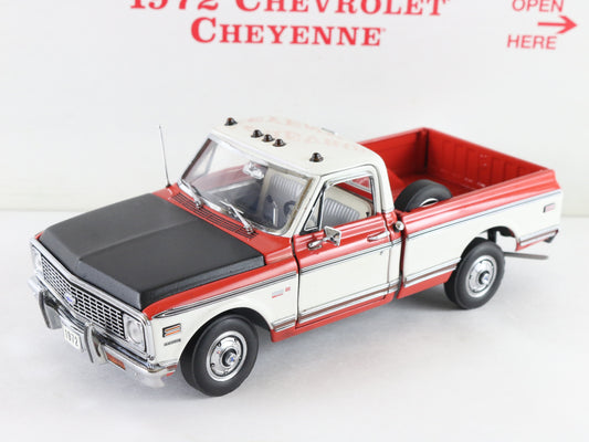 A 1972 Chevrolet Cheyenne model truck, likely a diecast scale model, shown from a three-quarter front angle. The truck features a white body WITH red, roof, and bed, and a black hood.
